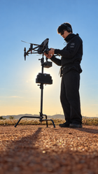 Operator preparing an Inspire 3 at working height on an XM2 Hardpoint and C-stand